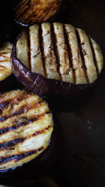 istock Griddled aubergines on a dark background 1269329713