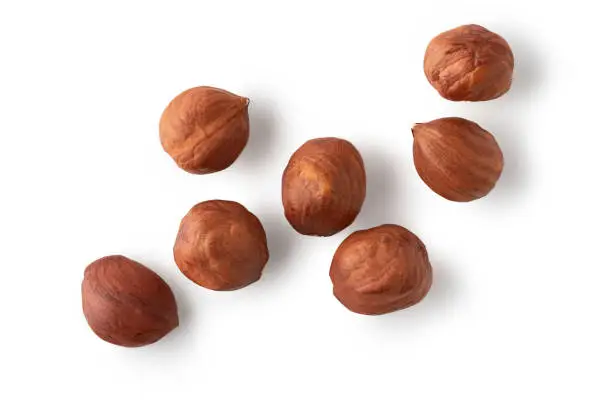 Shelled hazelnuts isolated on white background. Clipping path. Top view. Flay lay