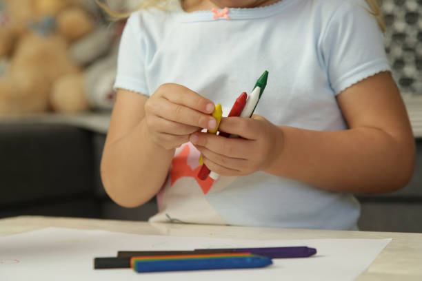 istock Child holding colorful crayons, close up 1269331144