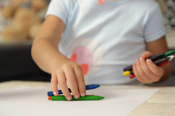 istock Child holding colorful crayons, close up 1269331740