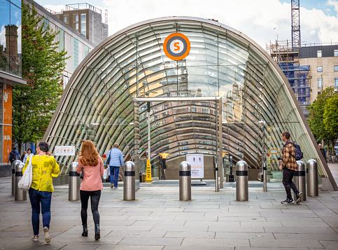 Glasgow, Scotland - People outside the entrance to the St. Enoch Subway station at the base of Buchanan Street in Glasgow's city centre.