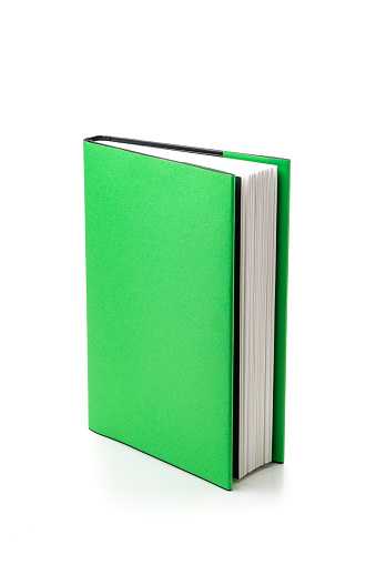 Green hard cover book isolated on white background. High resolution 42Mp studio digital capture taken with SONY A7rII and Zeiss Batis 40mm F2.0 CF lens