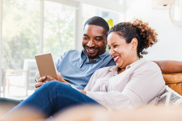 istock Husband and wife enjoy using digital tablet during coronavirus lockdown 1269341650