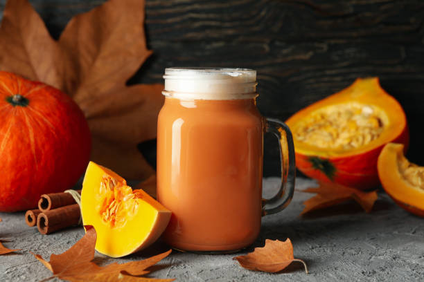 istock Composition with pumpkin latte, pumpkin, leaves and cinnamon on gray table 1269343379