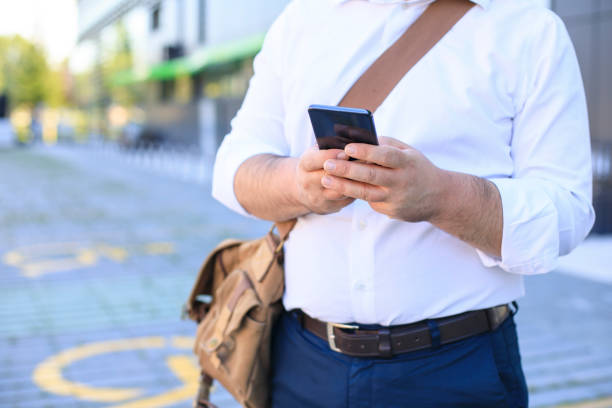 istock Successful businessman with mobile phone waiting for an Uber 1269343628