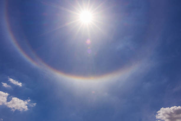 Fantastic beautiful sun halo phenomenon or sun with circular rainbow and fluffy altocumulus clouds over the skyscraper. Fantastic beautiful sun halo phenomenon or sun with circular rainbow and fluffy altocumulus clouds over the skyscraper. sundog stock pictures, royalty-free photos & images
