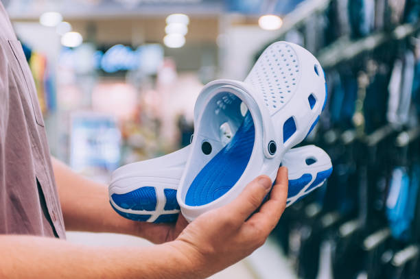 istock The guy is holding flip-flops in the supermarket. 1269348523