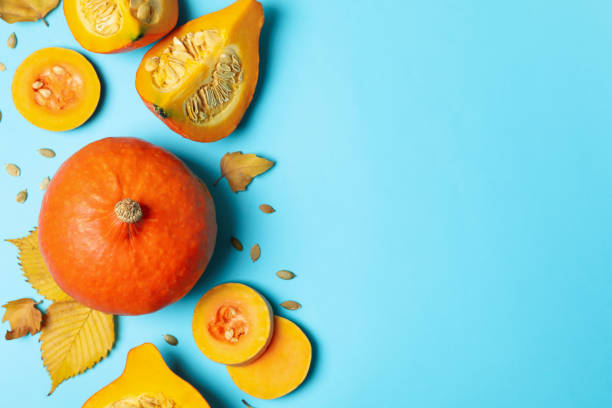 istock Composition with pumpkin, slices, leaves and seeds on blue background 1269348819