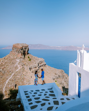 couple men and woman on vacation Santorini, View to the sea and Volcano from Fira the capital of Santorini island in Greece Europe