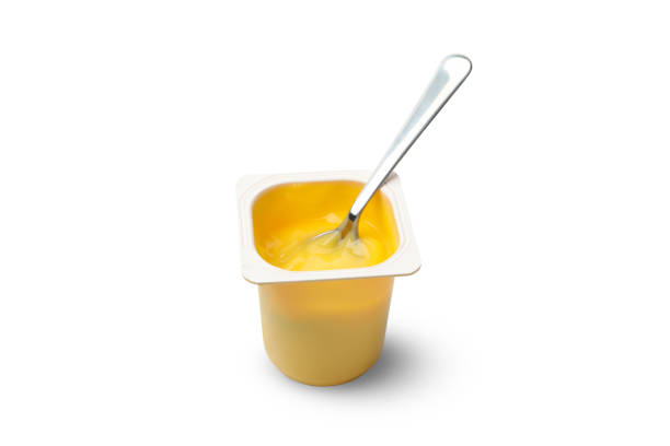 istock Plastic cup of yogurt and spoon isolated on white background 1269354871
