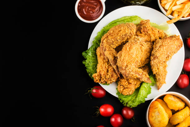 istock Fried chicken wings on wooden table. 1269356560