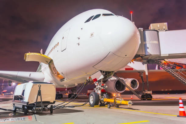 istock Night view of nose and cockpit a large plane during pre-flight maintenance service. 1269361151