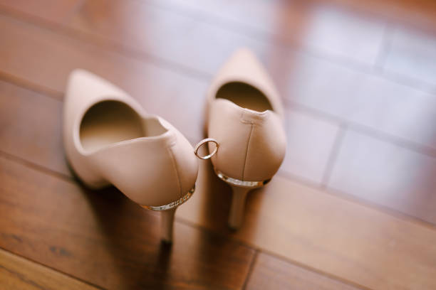 istock Wedding ring on the bride's cream shoes on a blurred background. 1269362113