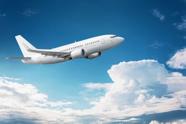istock Civil aircraft flying into deep blue skies with some clouds 1269362220