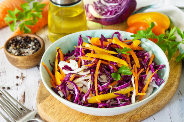 istock Cole Slaw. Cabbage salad in a bowl on a wooden table. 1269365300