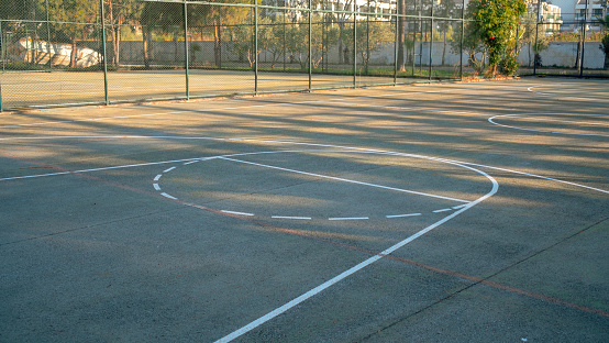 part of hard surface baskeball playground in public park or school outdoors