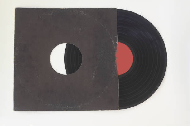 istock Aged black paper cover and vinyl LP record isolated on white background 1269367006