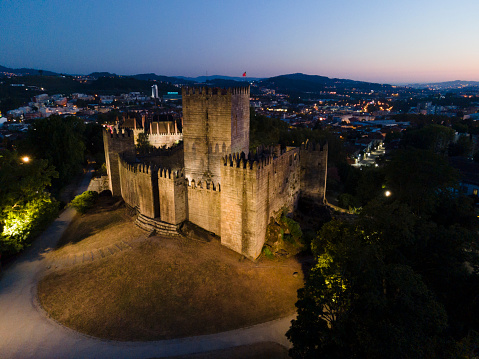 Guimarães, Portugal 28/7/2020: Guimarães Castle is connected to the birthplace of Portuguese nationality, it was here that King D. Afonso Henriques was born and founded the county of Portugal and the struggles for the independence of Portugal against the kings of Castile. The Castle is located on a hill and is classified as a national monument and represents one of the great historical landmarks of our country.