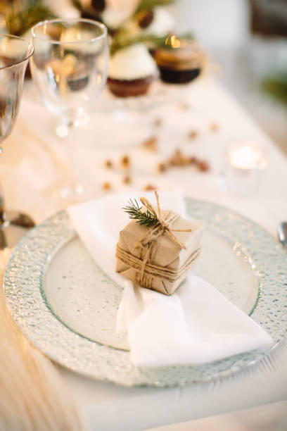 istock Small box with gift on table set for New Year and Christmas. Festive decor. 1269369191