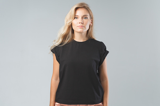 Blonde beautiful woman in black T-Shirt. Studio shoot