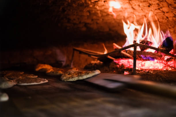 istock Cooking pita ( turkish traditional ramadan pide )  in a brick stone oven 1269370517