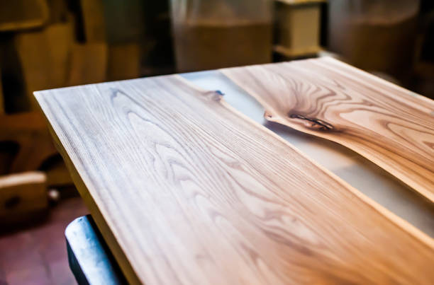 istock Epoxy-painted solid wood table top close-up in a carpentry workshop. Wood texture 1269371863
