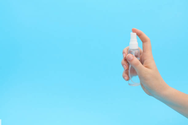 istock Alcohol sanitizer in a female hand on a blue background. 1269372431