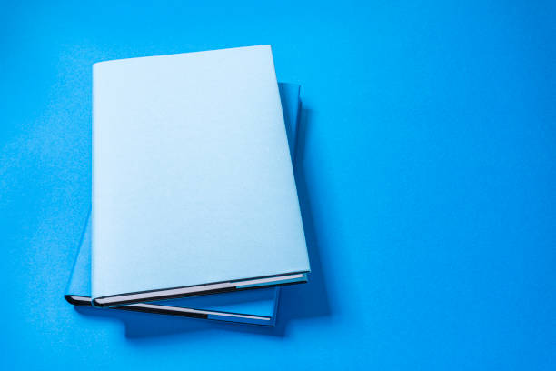 istock Blue colored cover book on blue background. Copy space 1269372563