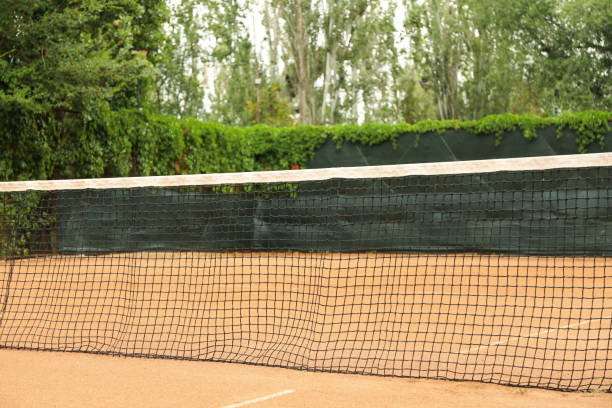 istock Clay tennis court with net, space for text 1269373764