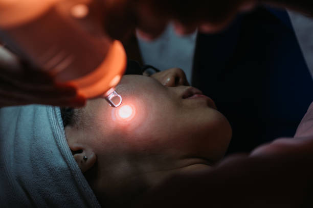 Asian chinese female receiving laser facial treatment at facial beauty salon stock photo