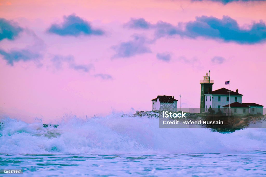 Pink Waves Watch Hill Light at sunset on a windy Rhode Island day Rhode Island Stock Photo