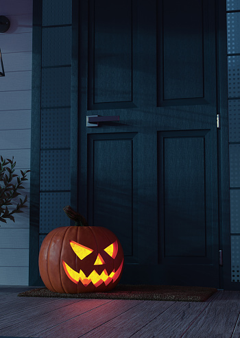 High resolution digital image of a Jack o' Lantern sitting on a mat, on the front porch of  a residence, next to the door. Plenty of text space.