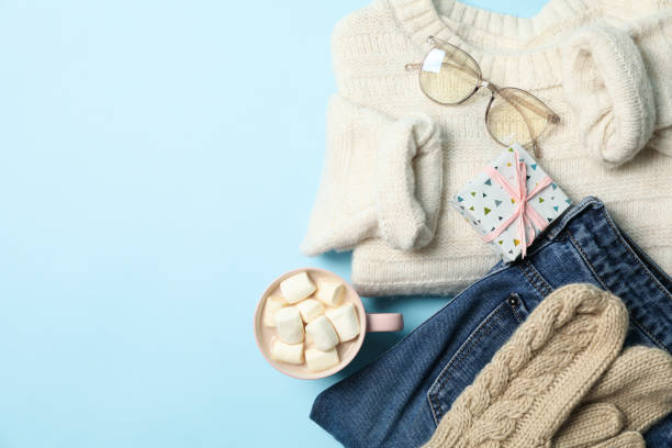 istock Winter concept with sweater and gift box on blue background 1269378800