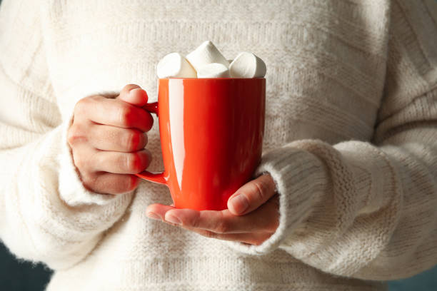 istock Woman hold cup of coffee with marshmallows, front view 1269379269