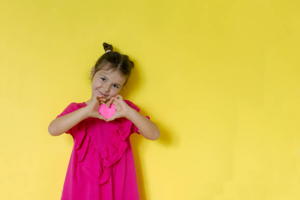 istock Girl holding paper heart 1269383009