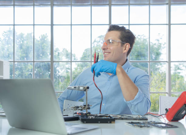 istock An engineer or technician western man working, examining or repairing computer motherboard equipment hardware in the lab or laboratory to upgrade processor chip electronic device technology . 1269383318