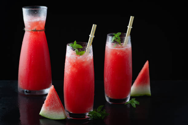 istock Summer cold drink with watermelon and mint on a black wooden background. 1269383417