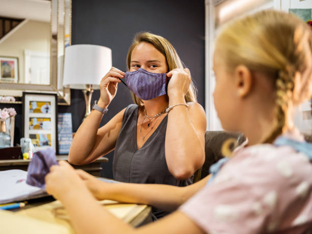 istock Mother and Daughter getting face masks on 1269384671