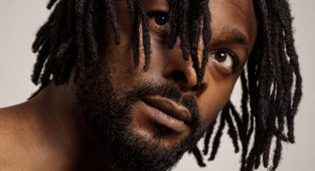 istock Close up Portrait of young afro man with dreadlocks white background. 1269386819