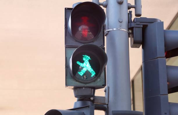 Traffic light and the symbol Berlin, Germany - August 20, 2017: Traffic light and the big green symbol called ampelmann ampelmännchen photos stock pictures, royalty-free photos & images