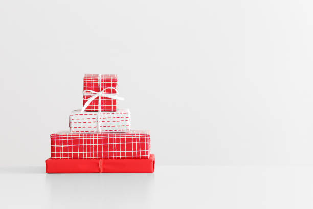istock Various types of red and white christmas gifts on a white table with blank copy space. 1269394022