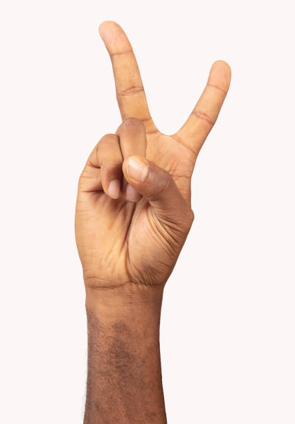 istock Black male hand making peace sign front of white background. 1269394146