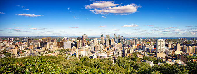 Panoramic Summer downtown Montreal skyline in late August afternoon with a very clear view all the way to Mount Saint-Bruno.