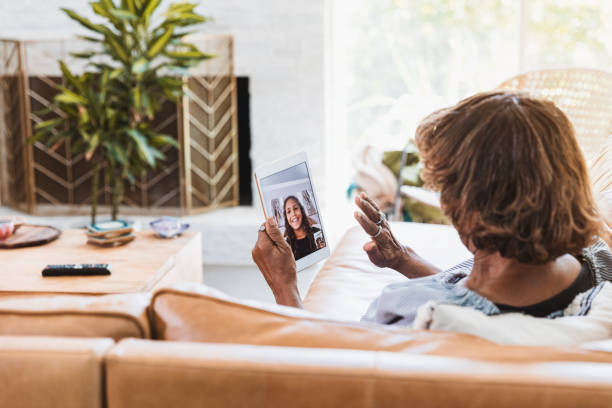 istock Unrecognizable grandmother waves to granddaughter while video conferencing 1269397294