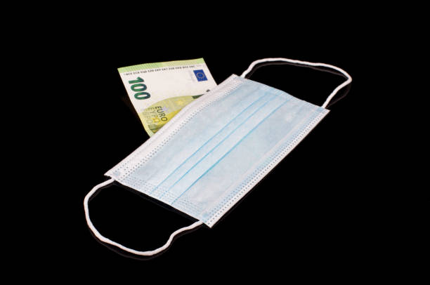 istock Euro banknote behind virus face mask 1269398800