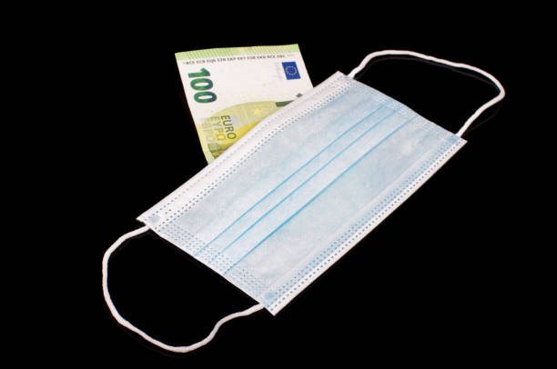 istock Euro banknote behind virus face mask 1269398810