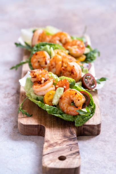 istock Lettuce wrapped Shrimp tacos with fresh tomato and avocado 1269399928