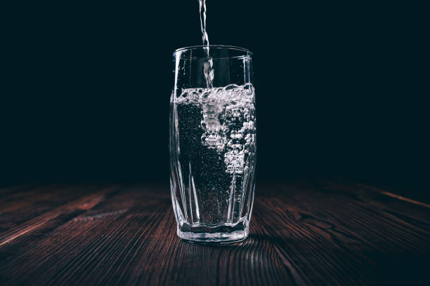 istock Water is poured into a transparent glass 1269402834