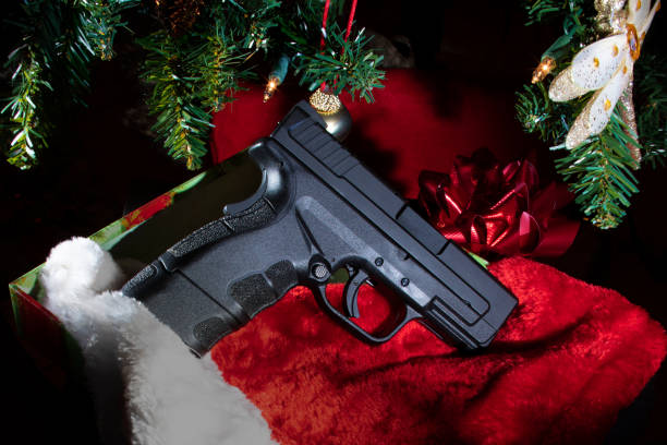 istock New handgun underneath a Christmas tree 1269403259