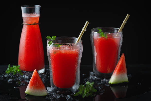 istock Summer cold drink with watermelon and mint on a black wooden background. Copy space 1269404136